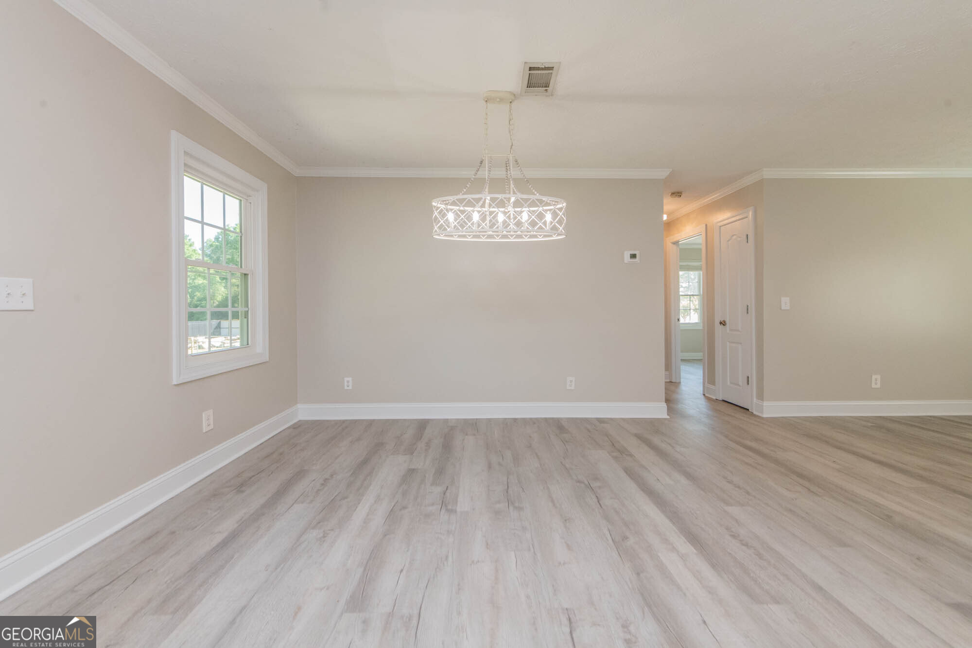 1661 Mule Creek Road Byron, GA 31008 - Photo 14 of 33 wooden floor in an empty room with a window