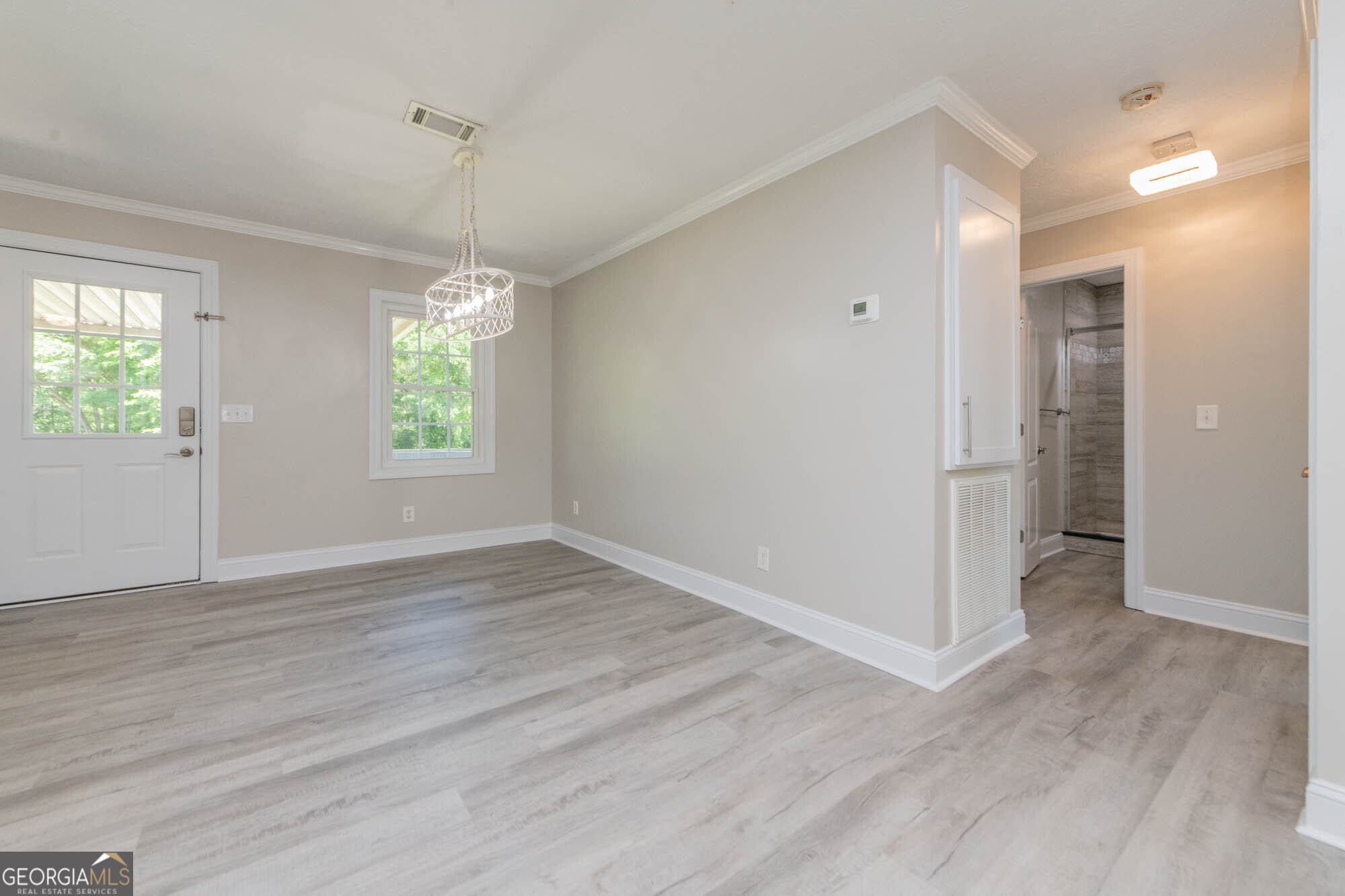 1661 Mule Creek Road Byron, GA 31008 - Photo 15 of 33 an empty room with wooden floor and windows