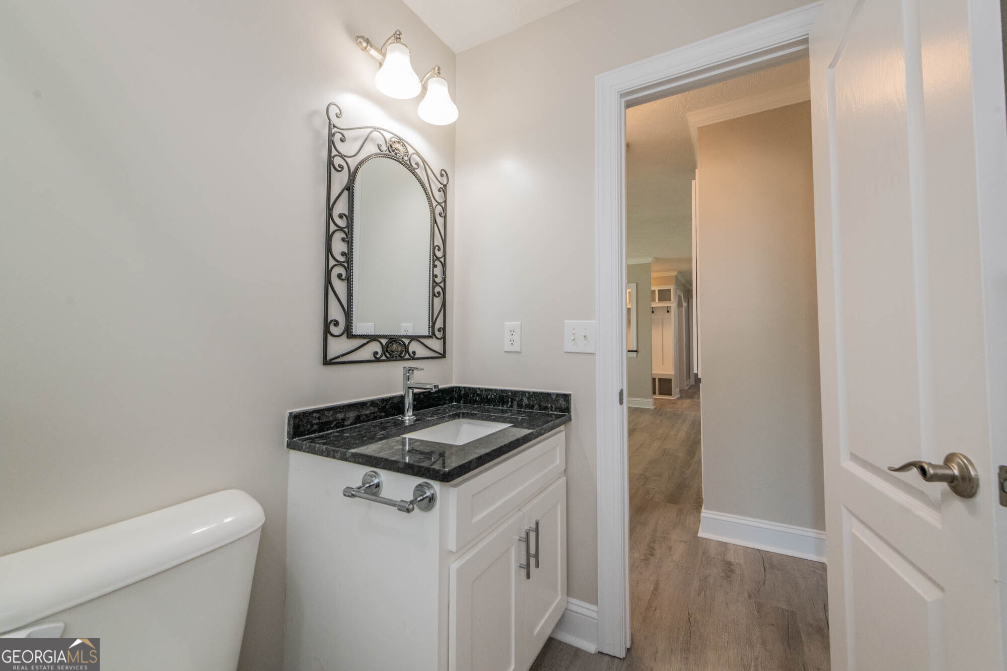 1661 Mule Creek Road Byron, GA 31008 - Photo 17 of 33 a bathroom with a granite countertop sink and a mirror