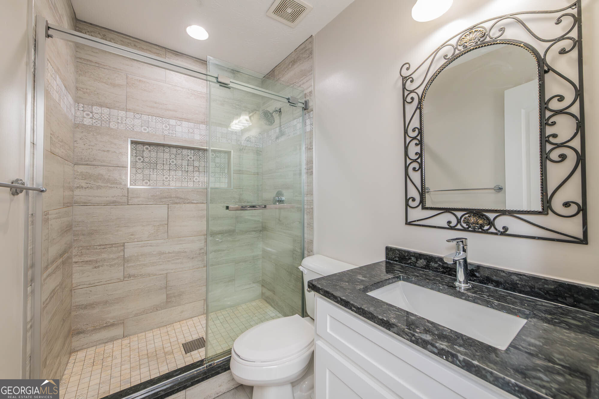 1661 Mule Creek Road Byron, GA 31008 - Photo 18 of 33 a bathroom with a granite countertop sink a toilet and shower
