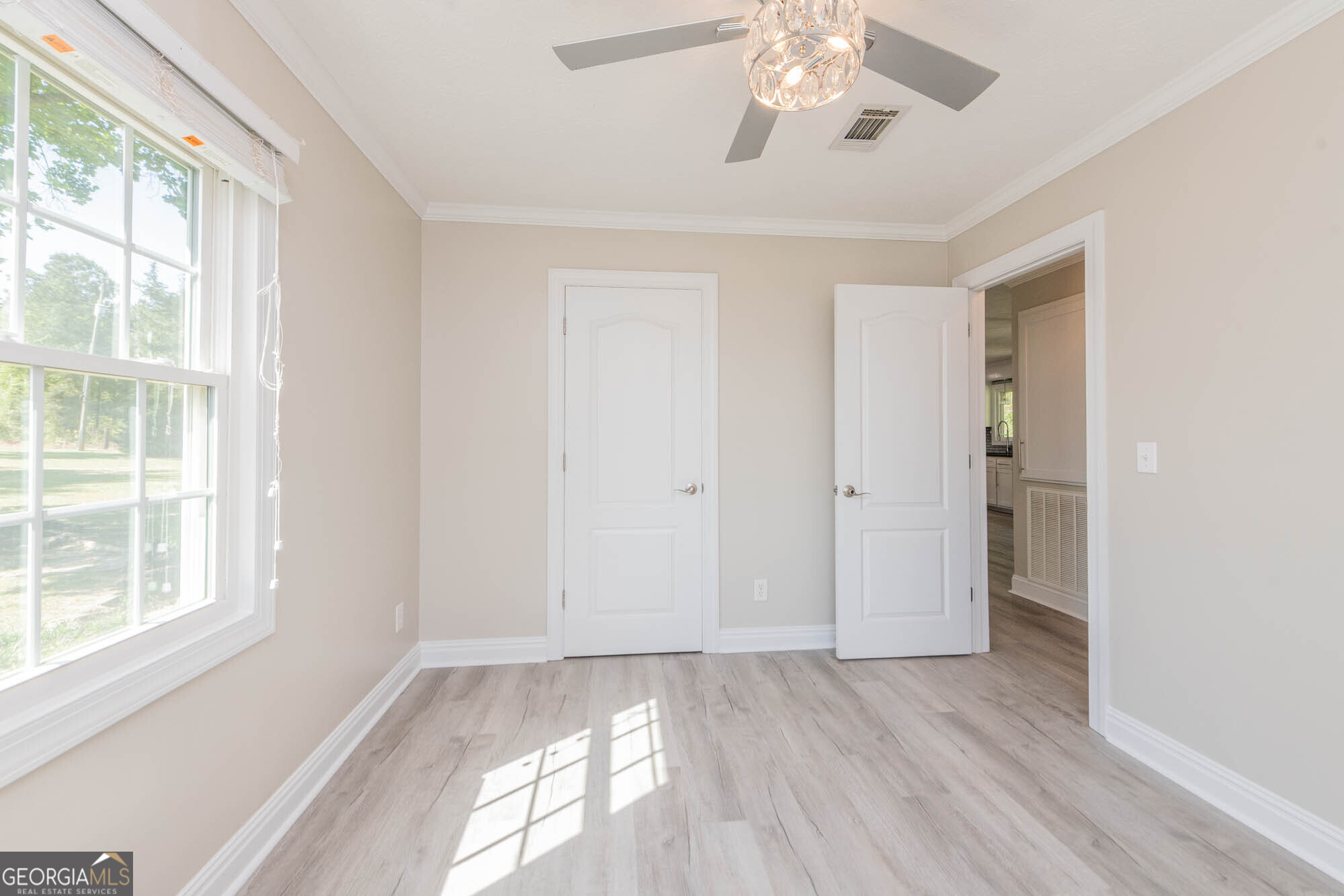 1661 Mule Creek Road Byron, GA 31008 - Photo 20 of 33 a view of an empty room with a window and wooden floor