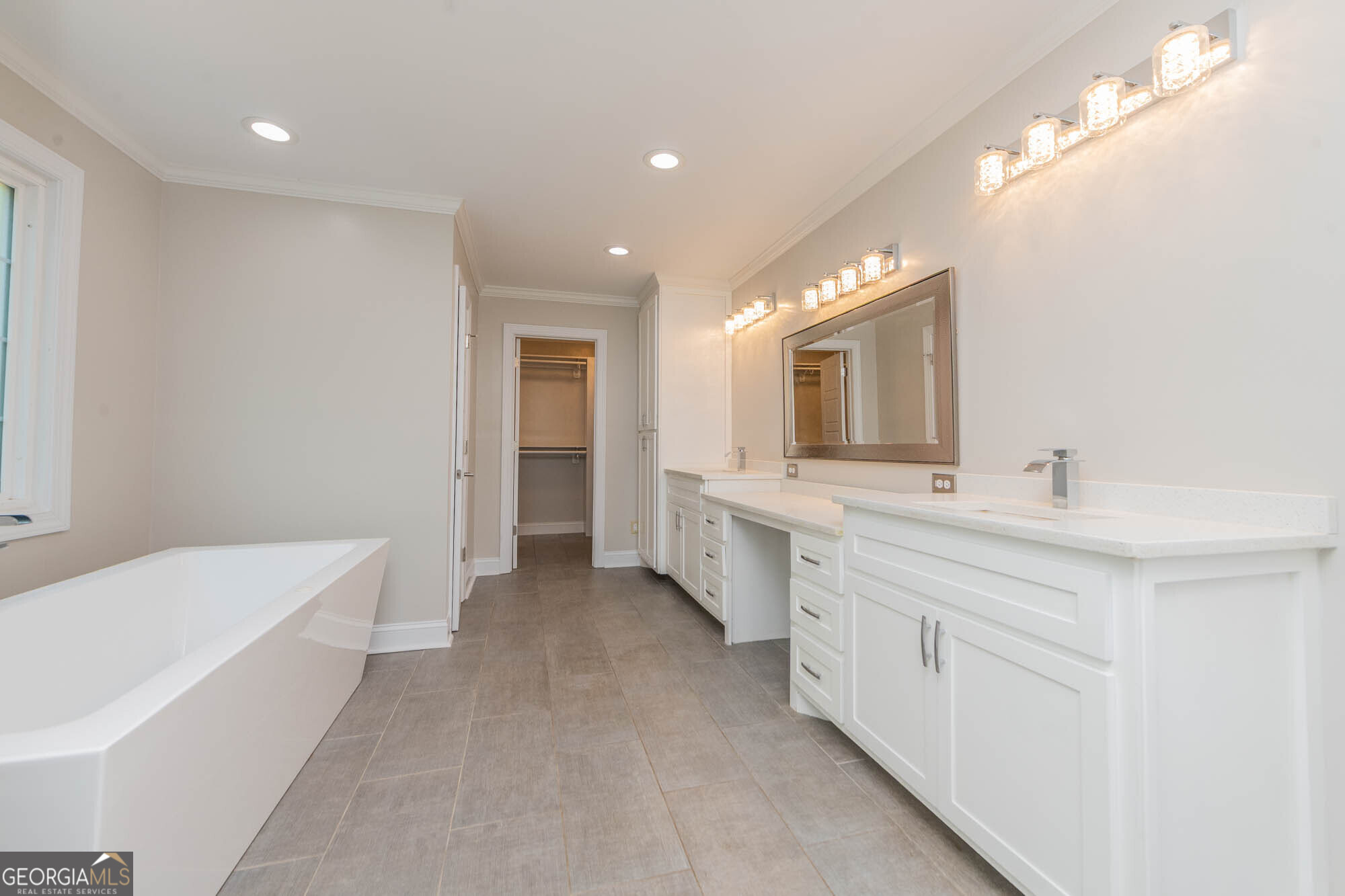 1661 Mule Creek Road Byron, GA 31008 - Photo 2 of 33 a bathroom with a double vanity sink a mirror and a bathtub