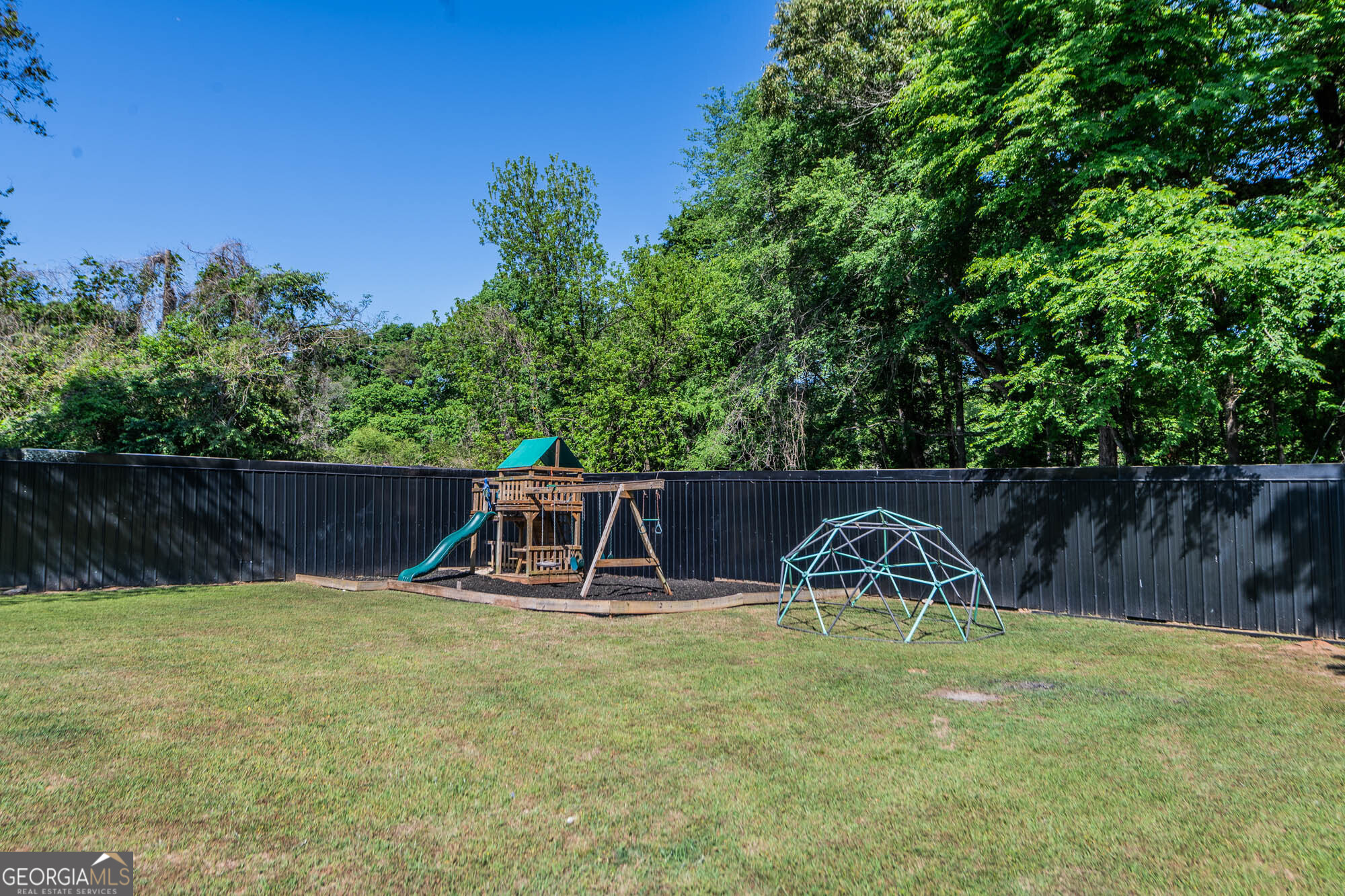 1661 Mule Creek Road Byron, GA 31008 - Photo 24 of 33 a backyard of a house with table and chairs