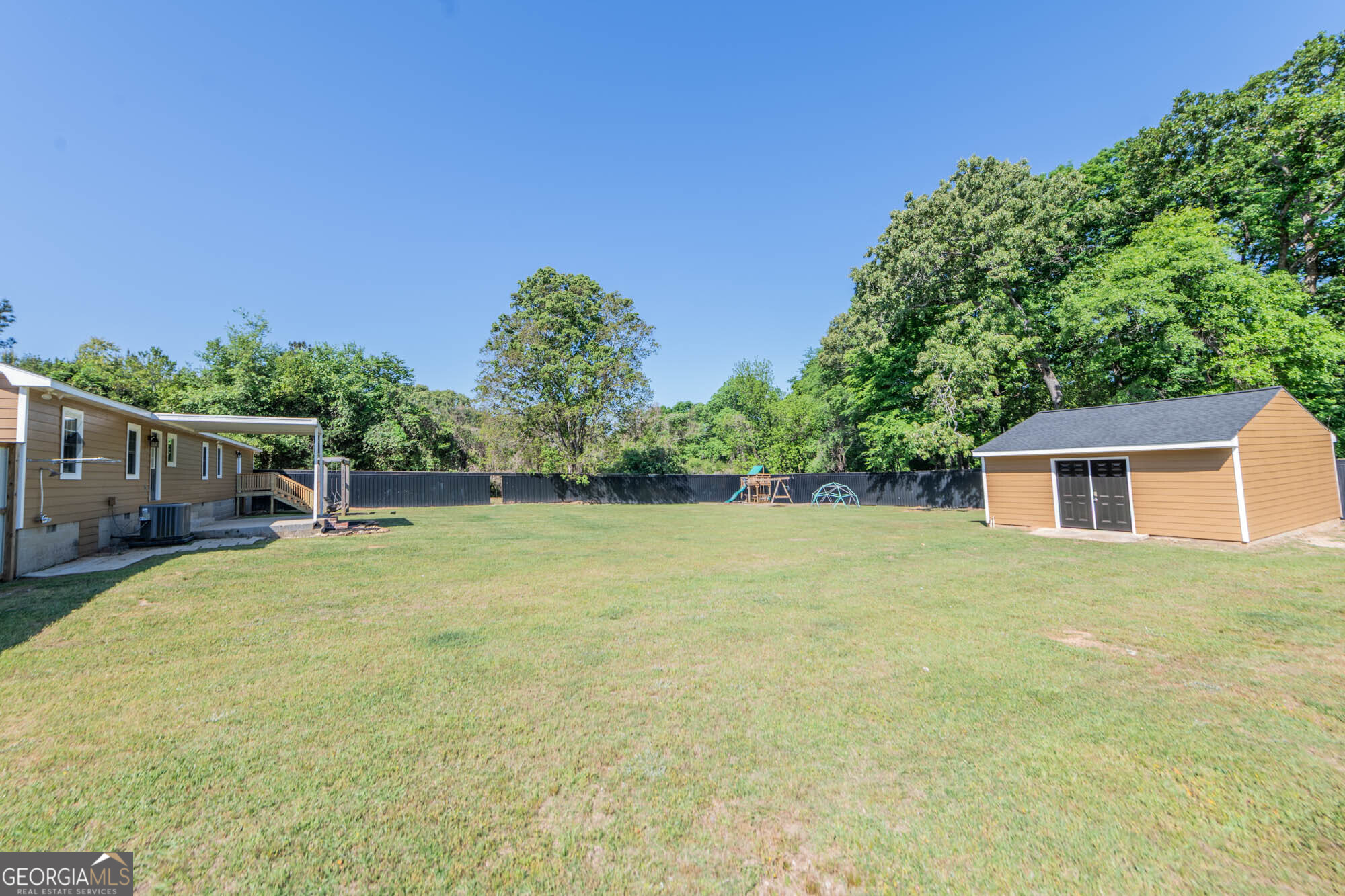 1661 Mule Creek Road Byron, GA 31008 - Photo 25 of 33 a backyard of a house with plants and tree