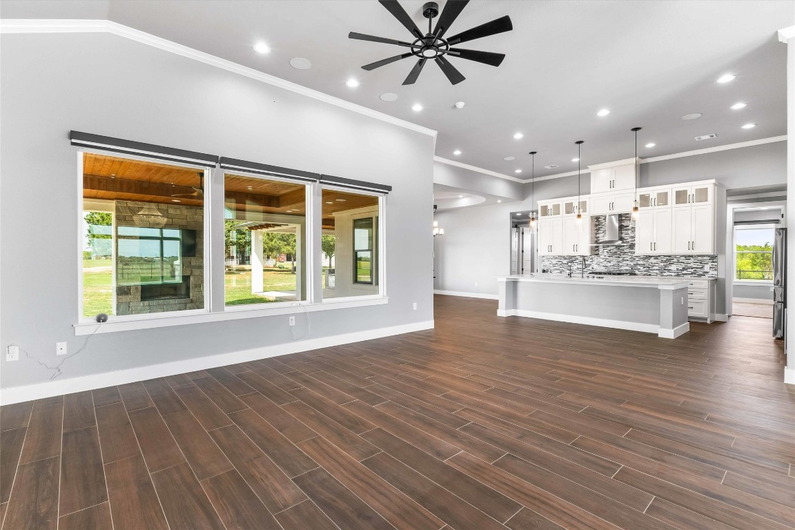 178 Balch Road Elgin, TX 78621 - Photo 8 of 40 a view of an empty room with a window and wooden floor