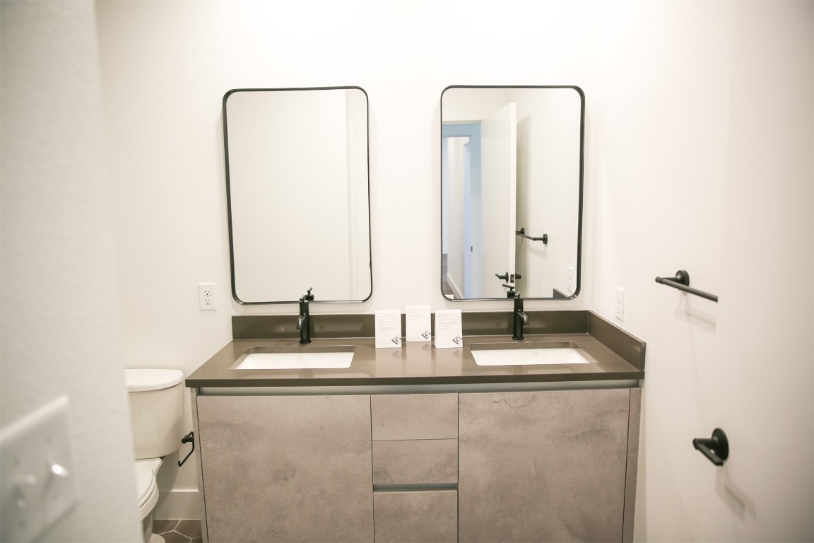 4315 South Congress Avenue, Unit 203 Austin, TX 78745 - Photo 10 of 15 a bathroom with double vanity and a mirror