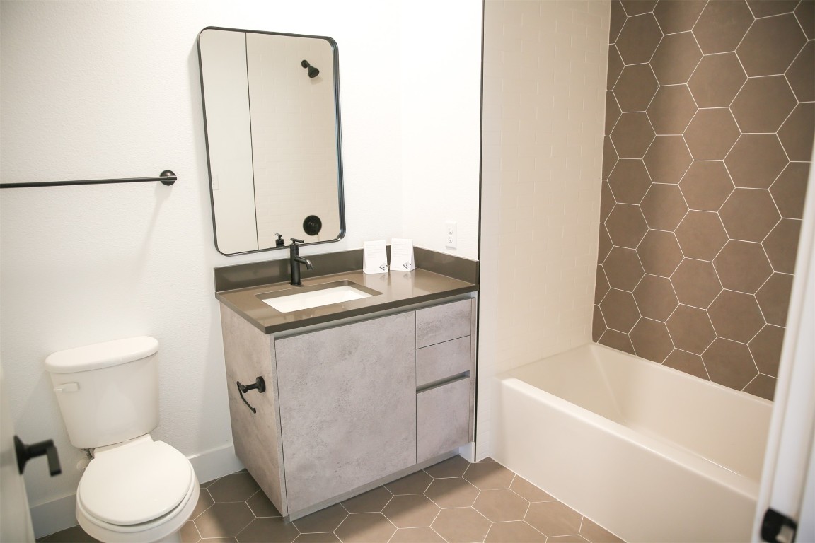 4315 South Congress Avenue, Unit 203 Austin, TX 78745 - Photo 12 of 15 a bathroom with a sink a toilet and a bathtub