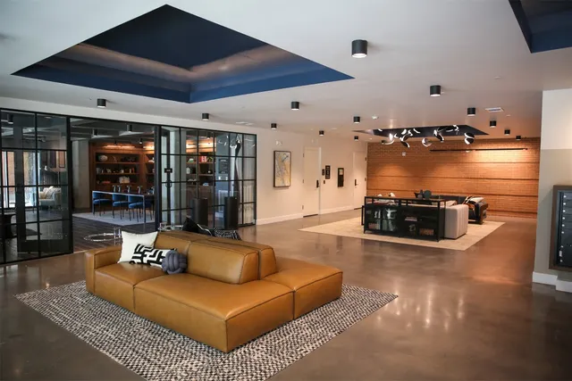 a living room with furniture and a chandelier