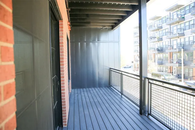 a view of a balcony from wooden floor