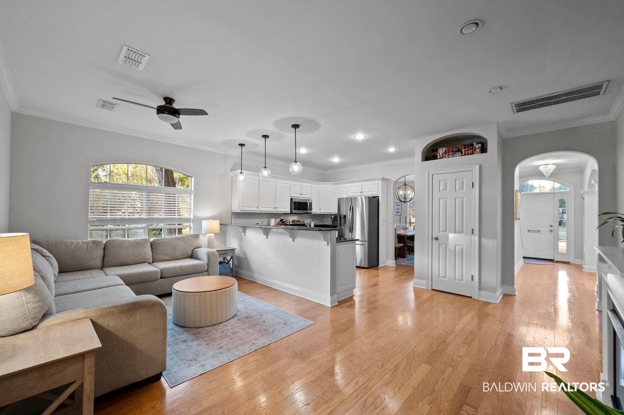 1825 Spring Hill Avenue Mobile, AL 36607 - Photo 15 of 43 Living area with arched walkways, crown molding, light wood finished floors, ceiling fan, and recessed lighting