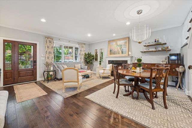 a dining room with furniture and wooden floor