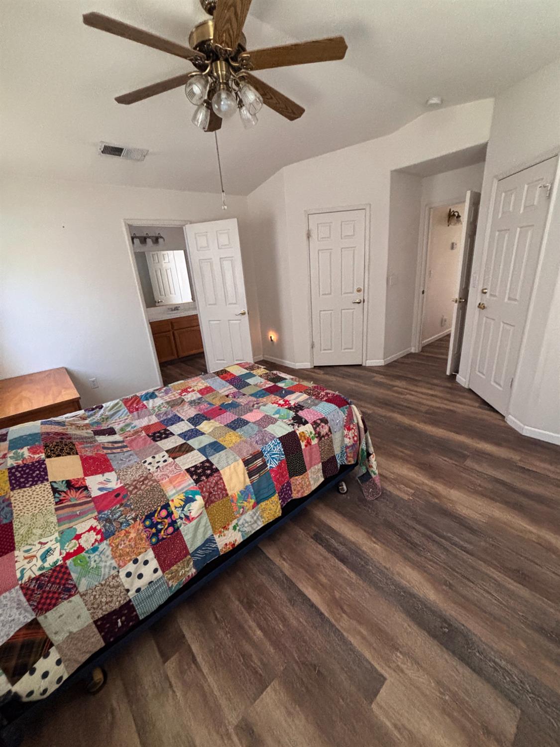 609 Merlot Avenue Madera, CA 93637 - Photo 25 of 45 a bedroom with a bed and wooden floor