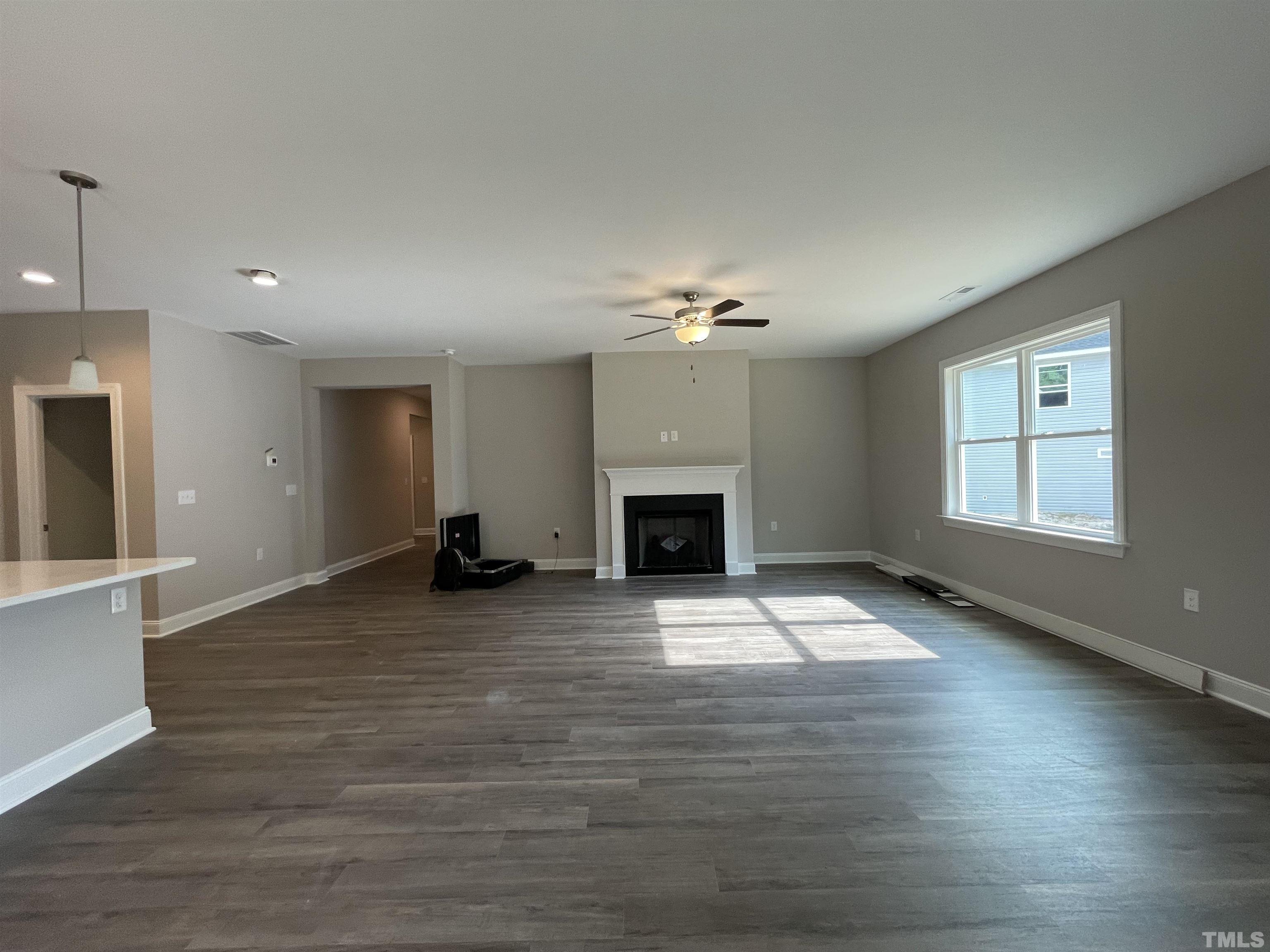 145 Wolf Ridge Willow Spring, NC 27592 - Photo 11 of 17 a view of an empty room with wooden floor and fireplace