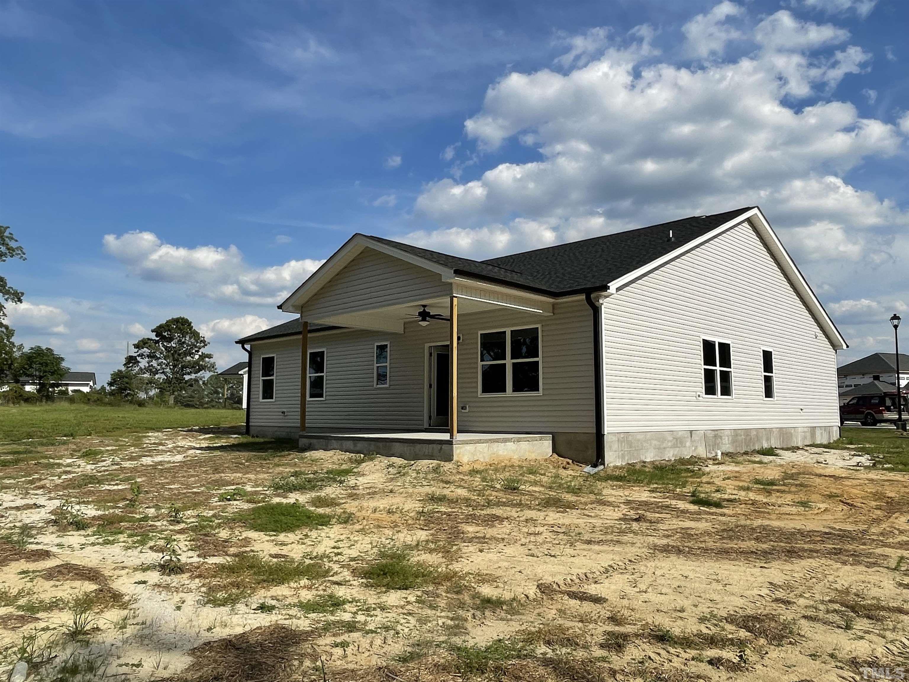 145 Wolf Ridge Willow Spring, NC 27592 - Photo 16 of 17 a house with yard in front of it