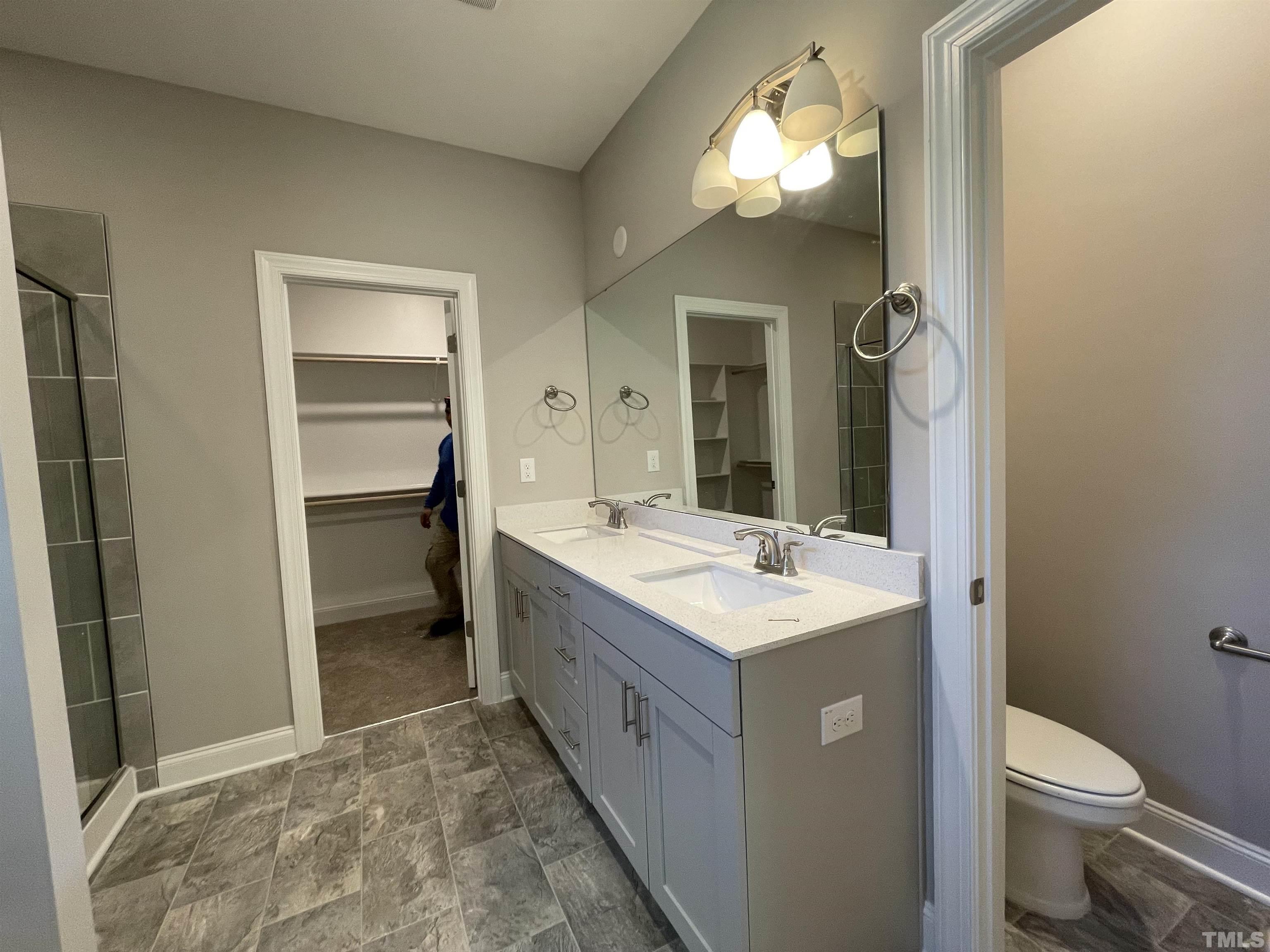145 Wolf Ridge Willow Spring, NC 27592 - Photo 17 of 17 a bathroom with a sink and a mirror