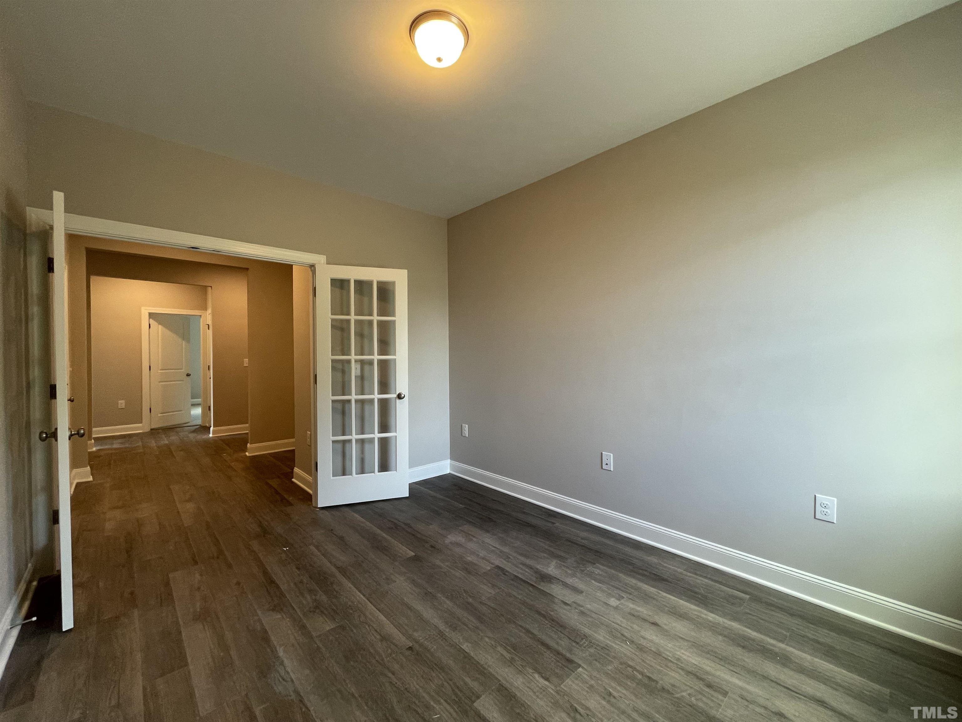 145 Wolf Ridge Willow Spring, NC 27592 - Photo 7 of 17 an empty room with wooden floor and windows