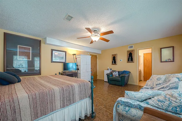 a bedroom with a bed couch and window