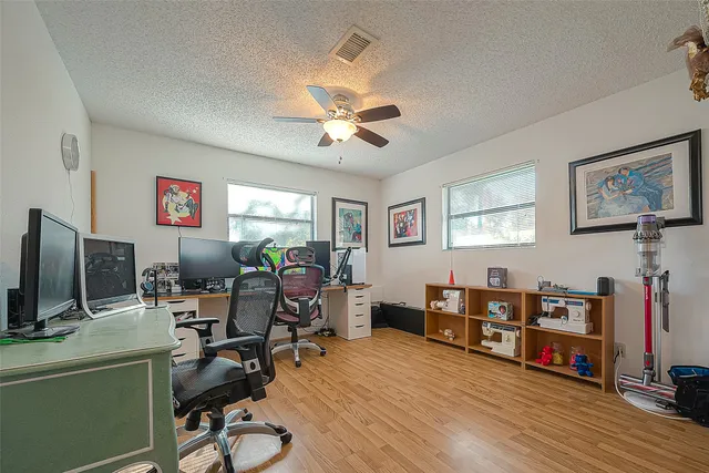 a view of a workspace with furniture and wooden floor
