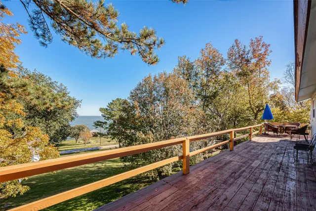 a view of balcony with wooden floor and fence