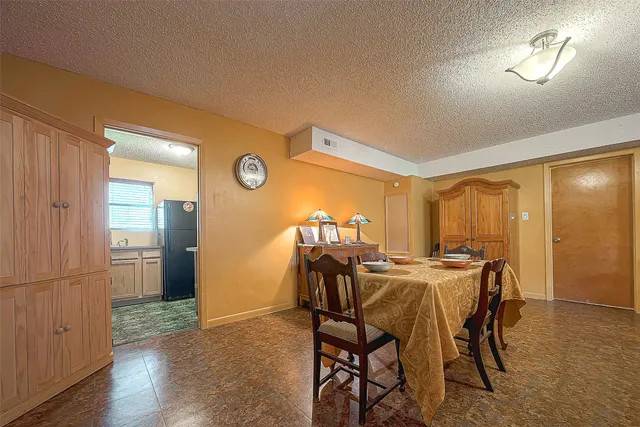 a view of a dining room with furniture and chandelier