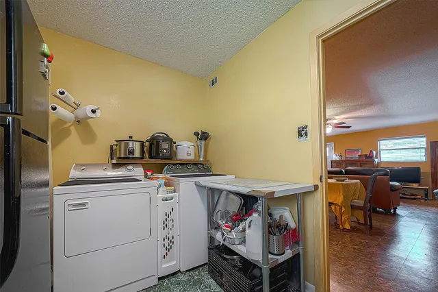 a utility room with dryer washer and storage