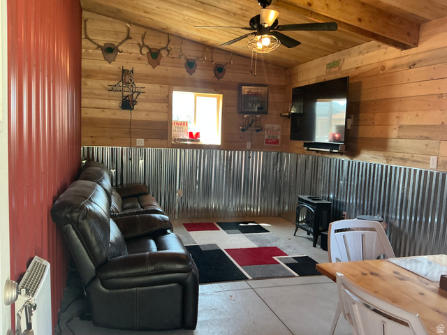 98 Main Street Manila, UT 84046 - Photo 32 of 36 Interior space featuring wood-finish paneling, corrugated metal wainscoting, and a wood-finish ceiling with exposed beams