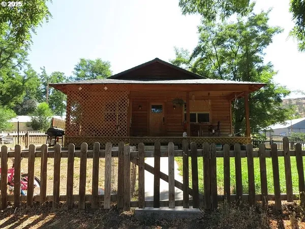 a view of house with yard and sitting area
