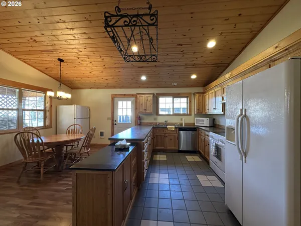 a kitchen with refrigerator cabinets and dining table