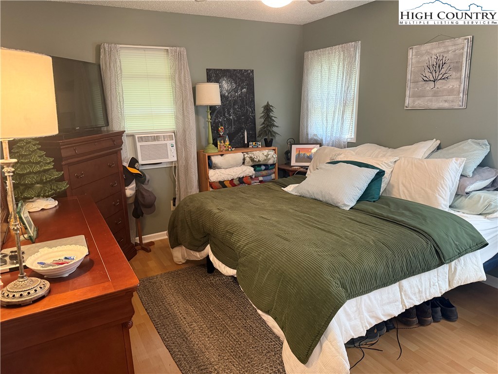 61 River Loop Newland, NC 28657 - Photo 15 of 38 a bedroom with a bed and wooden floor