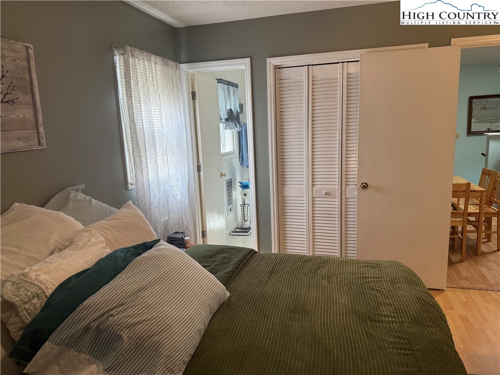 61 River Loop Newland, NC 28657 - Photo 17 of 38 a bedroom with a bed and a mirror