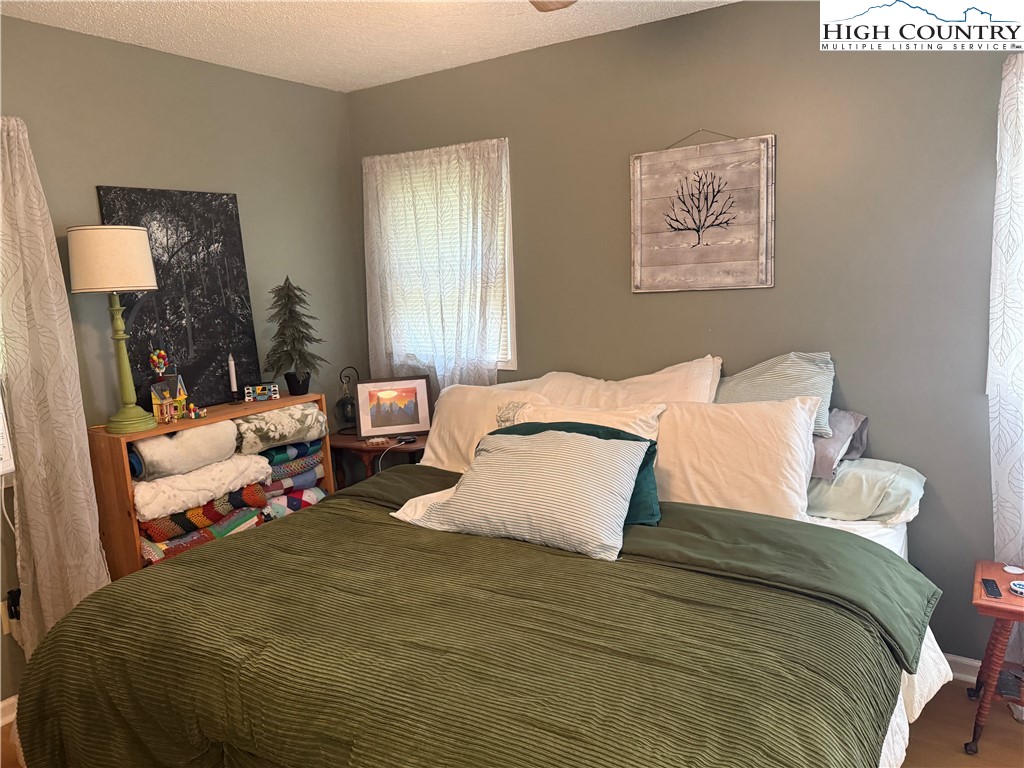 61 River Loop Newland, NC 28657 - Photo 18 of 38 a bedroom with a bed and wooden floor