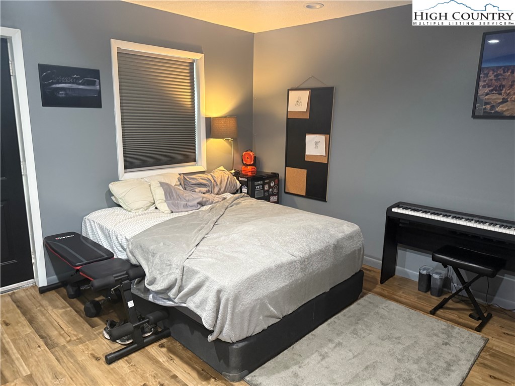 61 River Loop Newland, NC 28657 - Photo 23 of 38 a bedroom with a bed and wooden floor