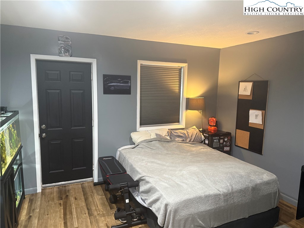 61 River Loop Newland, NC 28657 - Photo 24 of 38 a bedroom with a bed and a mirror
