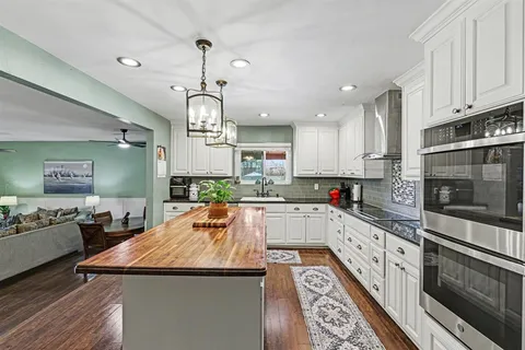 a kitchen with stainless steel appliances granite countertop a sink and stove