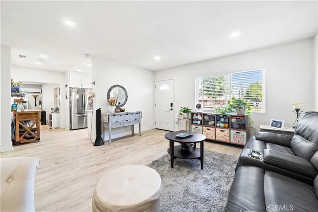 a living room with furniture a rug and a table