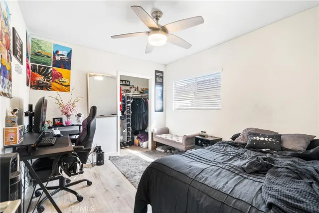 a bedroom with a bed and a desk