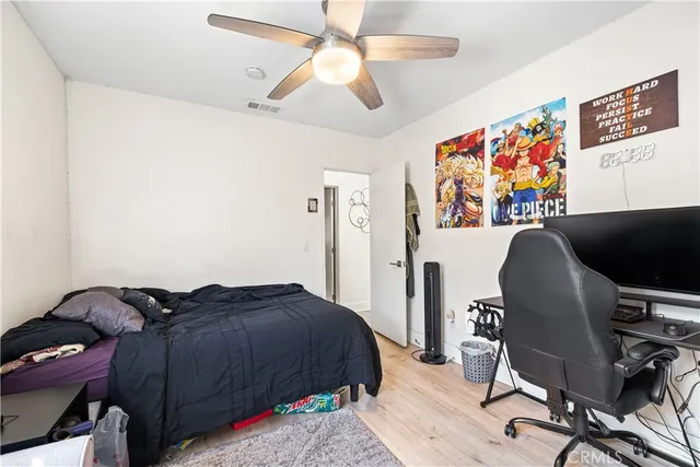 a bedroom with a bed and a desk