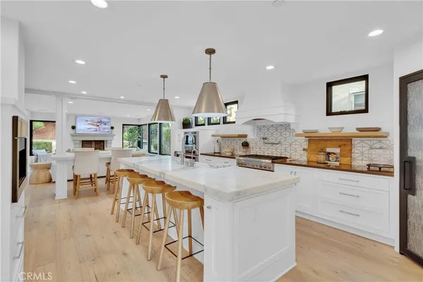 a large kitchen with a large counter top appliances and cabinets