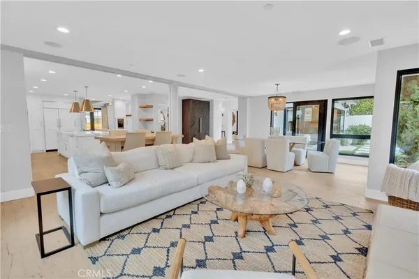 a living room with furniture and a painting on the wall
