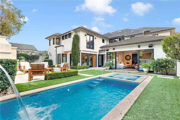 a view of an house with swimming pool and porch