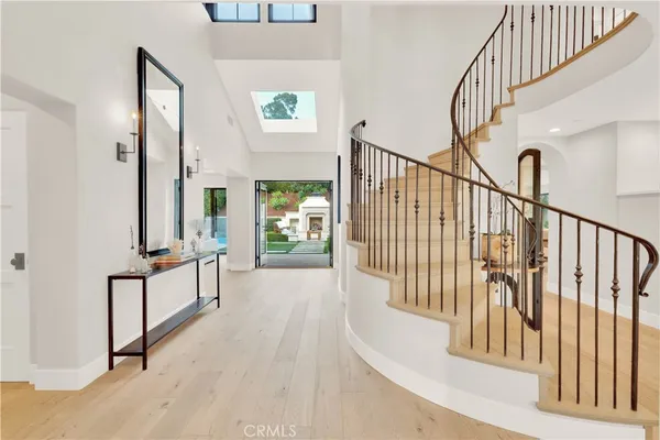 a view of staircase with lots of frames on wall and a window