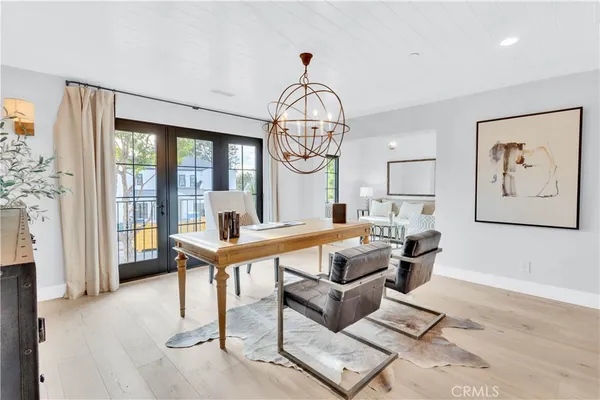 a living room with furniture a table and a large window