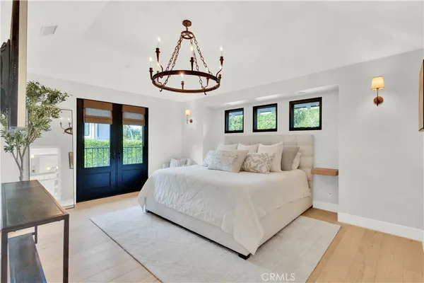 a bedroom with a large bed and a window