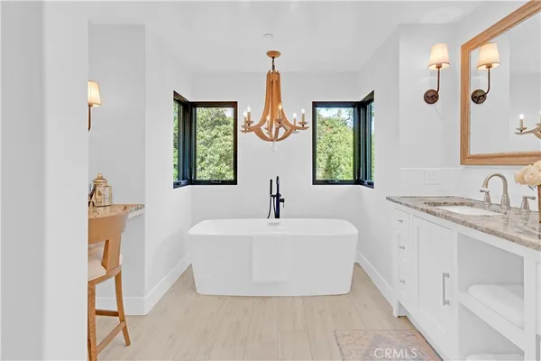 a bathroom with a double vanity sink mirror and window