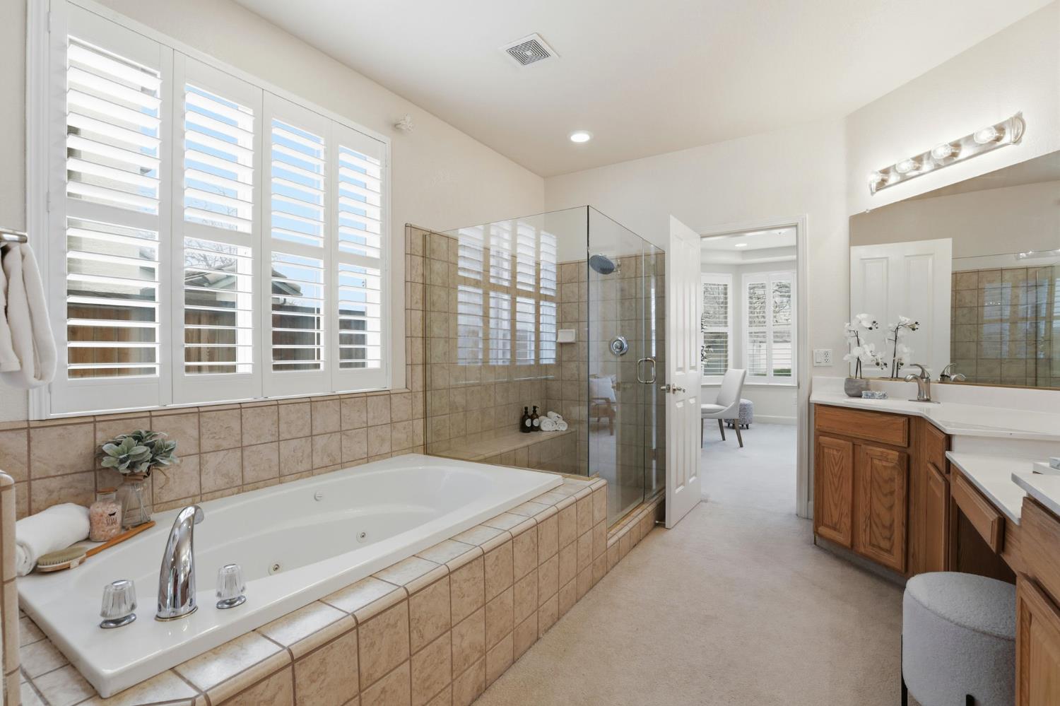 2624 West Pintail Way Elk Grove, CA 95757 - Photo 37 of 65 a spacious bathroom with a granite countertop tub sink and mirror