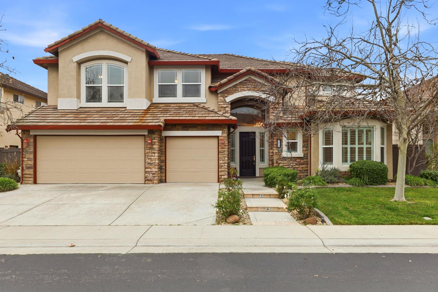 2624 West Pintail Way Elk Grove, CA 95757 - Photo 57 of 65 a front view of a house with a yard and garage
