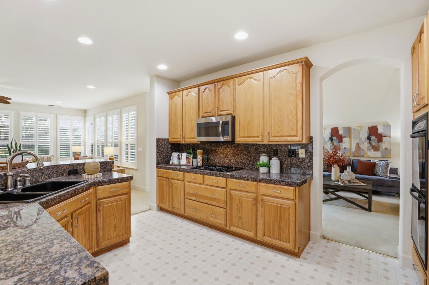 2624 West Pintail Way Elk Grove, CA 95757 - Photo 7 of 65 a kitchen with stainless steel appliances granite countertop a stove a sink and a refrigerator