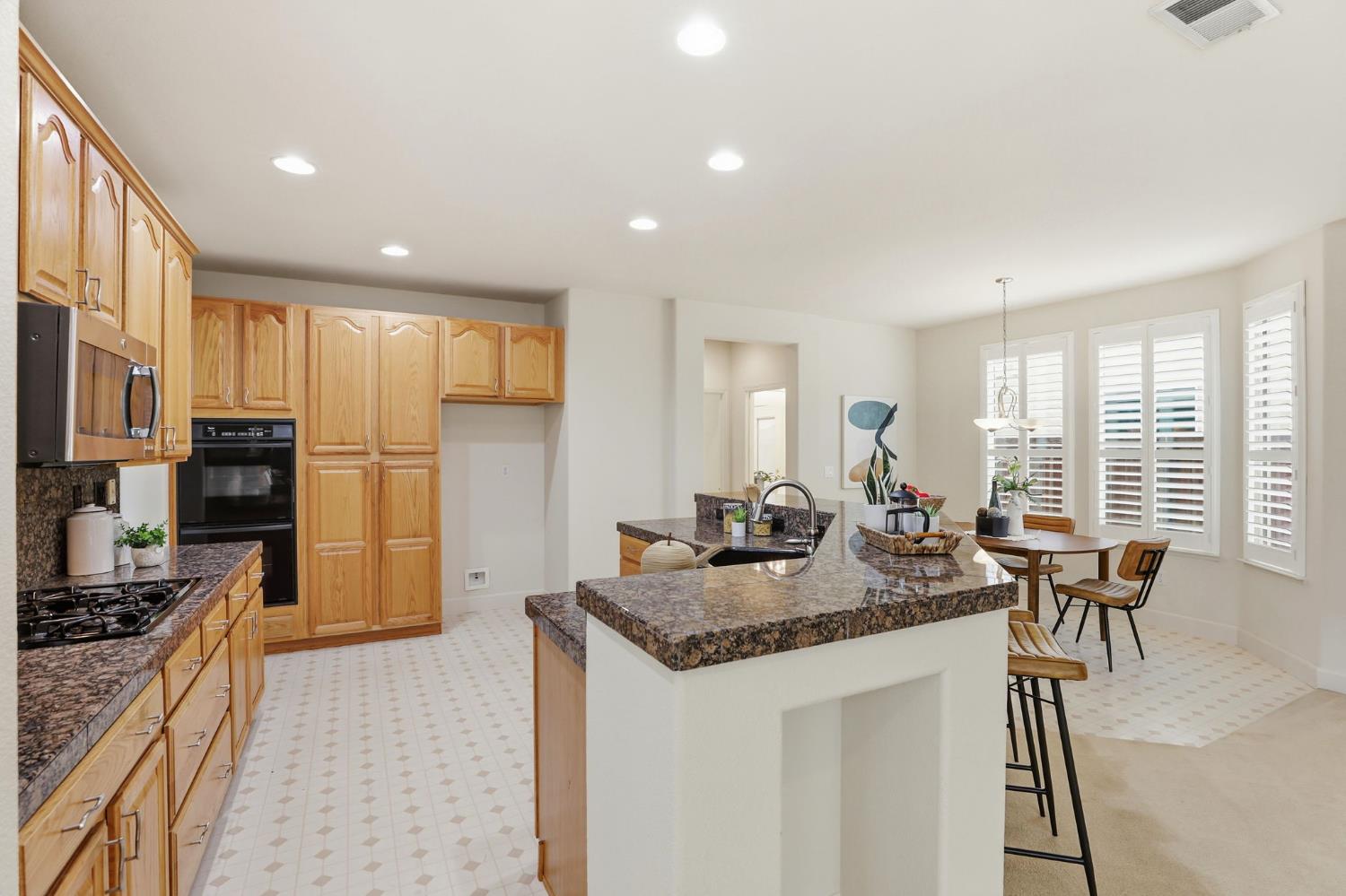 2624 West Pintail Way Elk Grove, CA 95757 - Photo 10 of 65 a kitchen with stainless steel appliances granite countertop sink stove refrigerator and cabinets