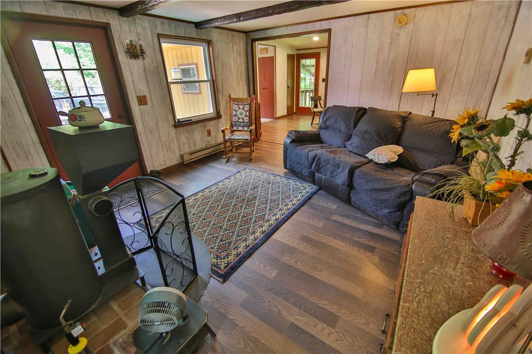 8 Cross Rds Drive Jim Thorpe, PA 18229 - Photo 11 of 32 A welcoming living room featuring rich wood-look flooring and exposed ceiling beams.
