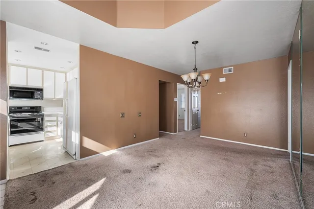 a view of an empty room with a fireplace and a window